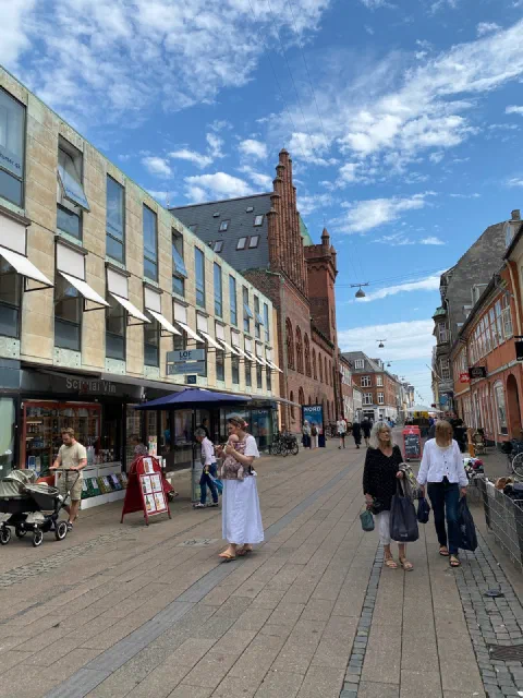 Pedestrian street in Helsingør in the sun, a red-brick facade at its end