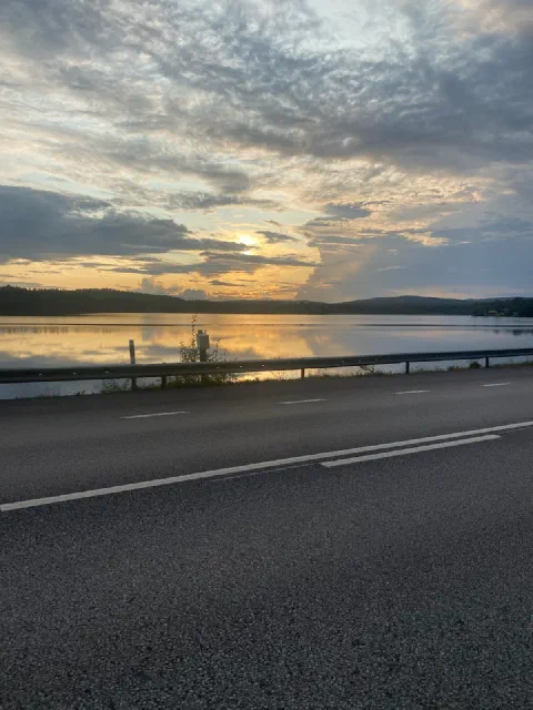 Golden sunset over a lake, seen from the road