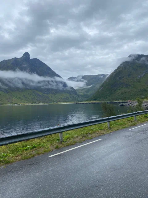 Fjord with a pointed mountain and low mist
