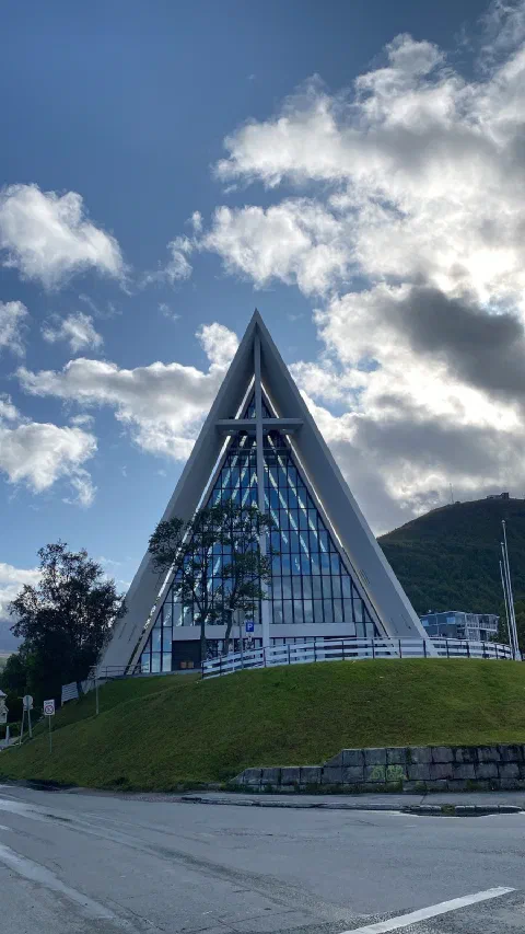 The Arctic Cathedral in Tromsø, its triangular facade against the clouds