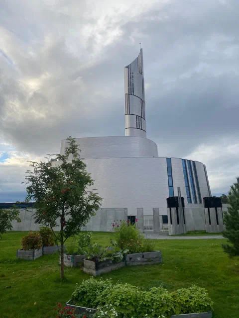 The Northern Lights Cathedral in Alta, its spire against the clouds